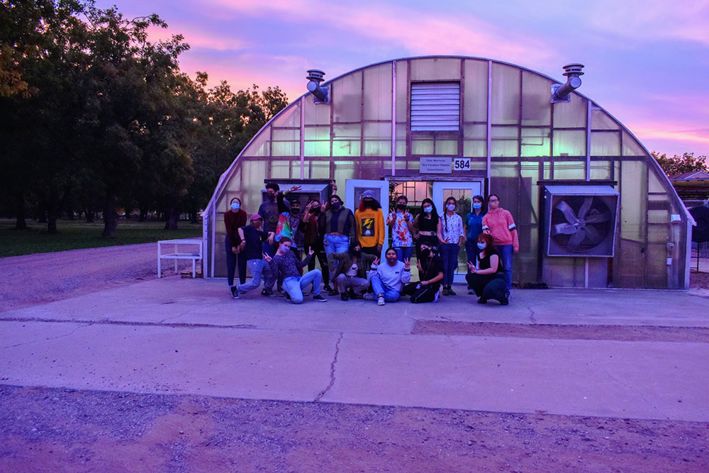 Students in front of greenhouse